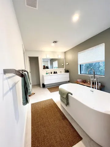 a bedroom with furniture and a wooden floor