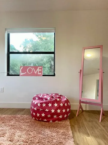 a bedroom with a bed and a potted plant