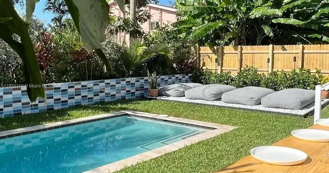 a view of a backyard with swimming pool