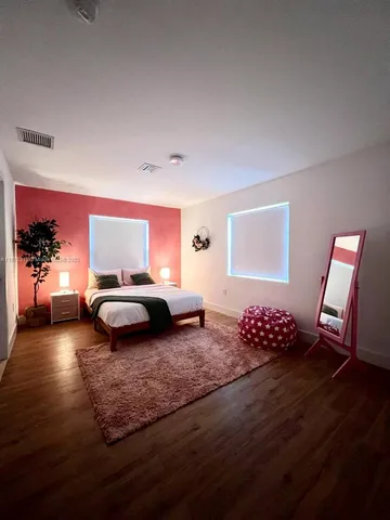 a living room with a couch and a wooden floor