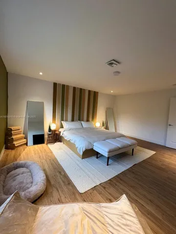 a bedroom with two beds and a couch