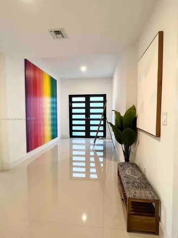 a bedroom with a bed and a large mirror