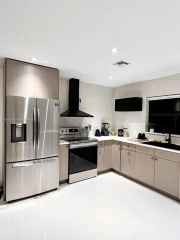 a large kitchen with cabinets and stainless steel appliances