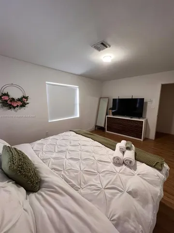 a kitchen with a table chairs microwave and cabinets