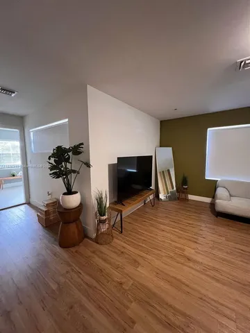 a kitchen with stainless steel appliances kitchen island granite countertop a sink and a stove top oven with white cabinets