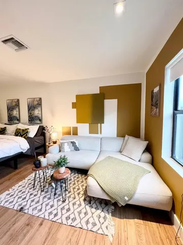 a bedroom with a table chairs and a bed