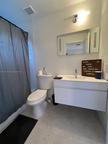 an aerial view of a house with garden space and sitting area