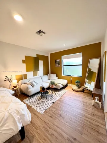 a bed sitting in front of a window