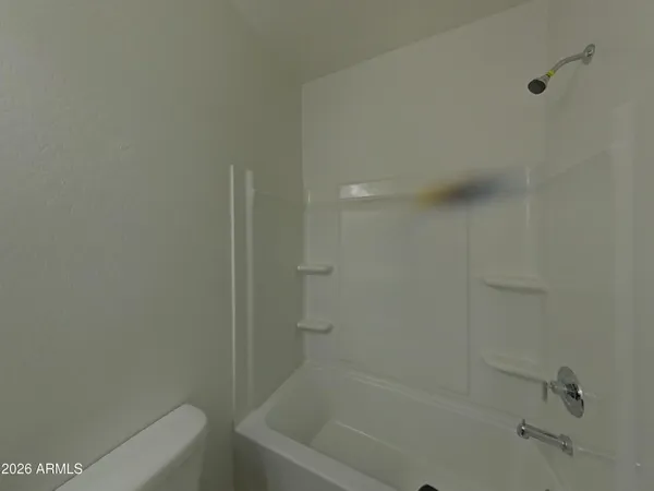 a bathroom with a toilet sink vanity and mirror