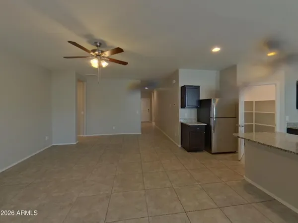 a view of kitchen with refrigerator and microwave