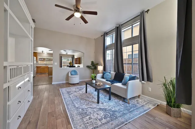 a view of backyard with table and chairs and wooden fence