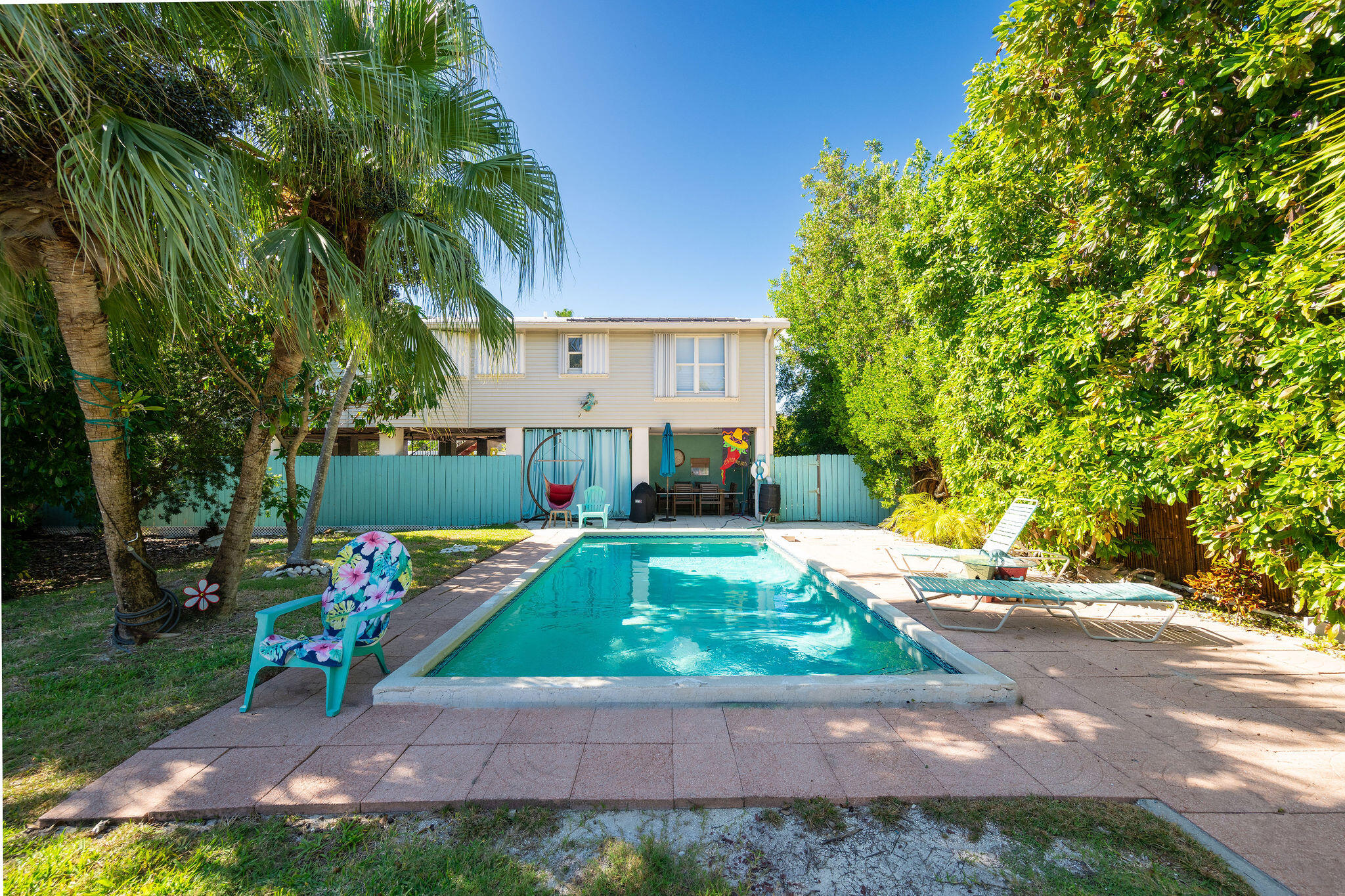 206 4th Street Key West, FL 33040 - Photo 18 of 44 a view of a backyard with a table and chairs under an umbrella