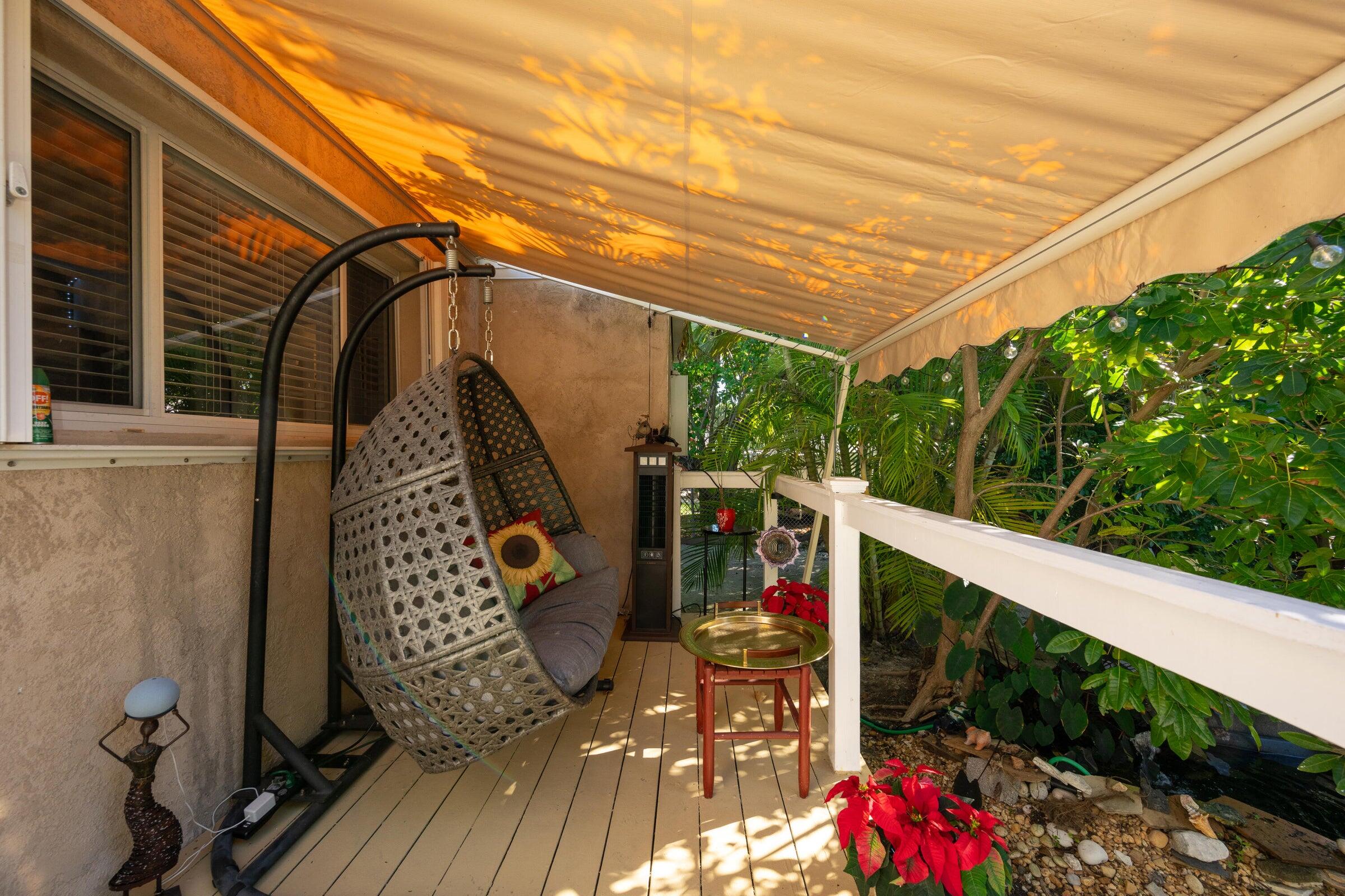 206 4th Street Key West, FL 33040 - Photo 22 of 44 a view of balcony with wooden floor and outdoor seating