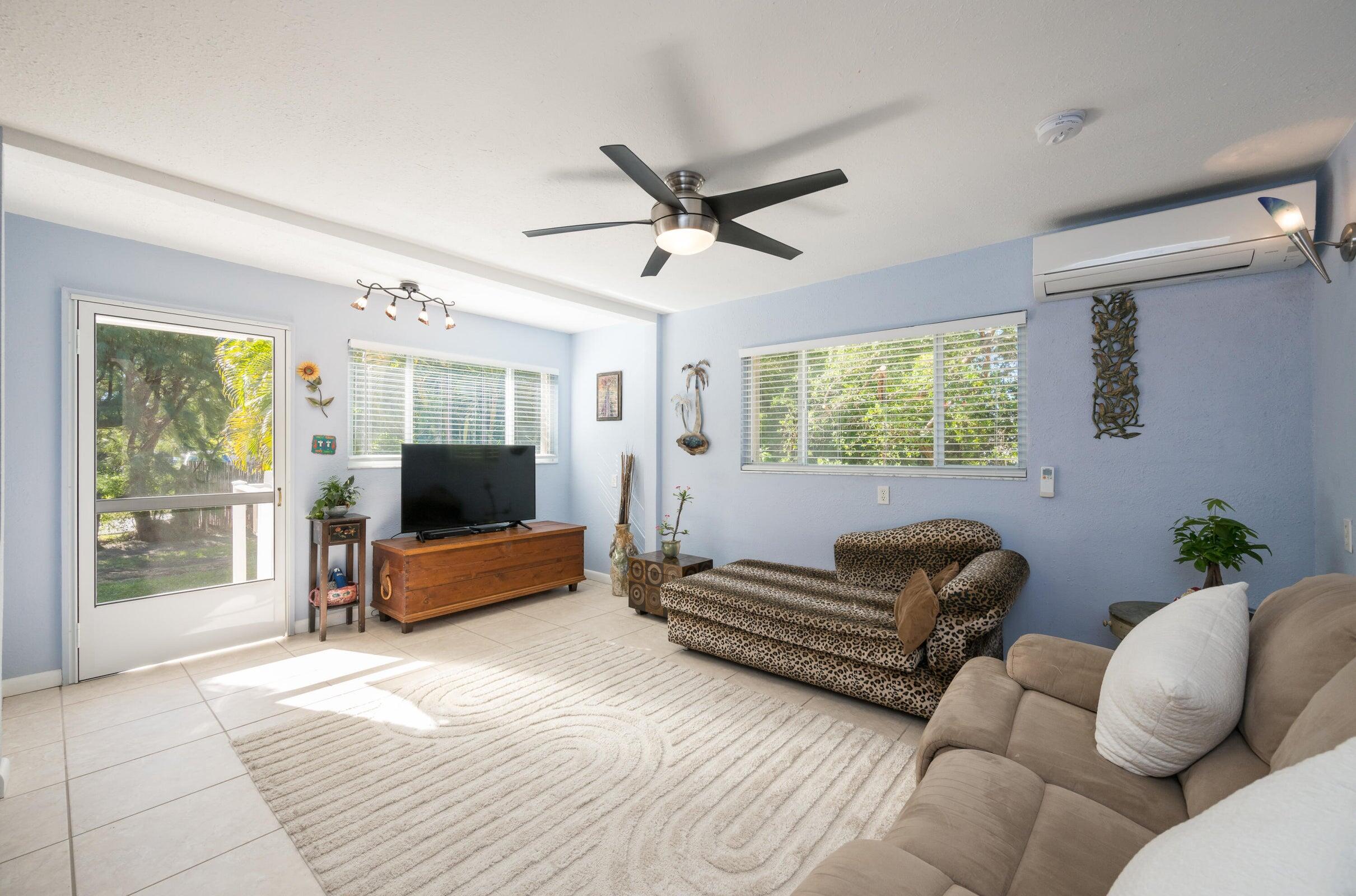 206 4th Street Key West, FL 33040 - Photo 23 of 44 a living room with furniture ceiling fan and a window