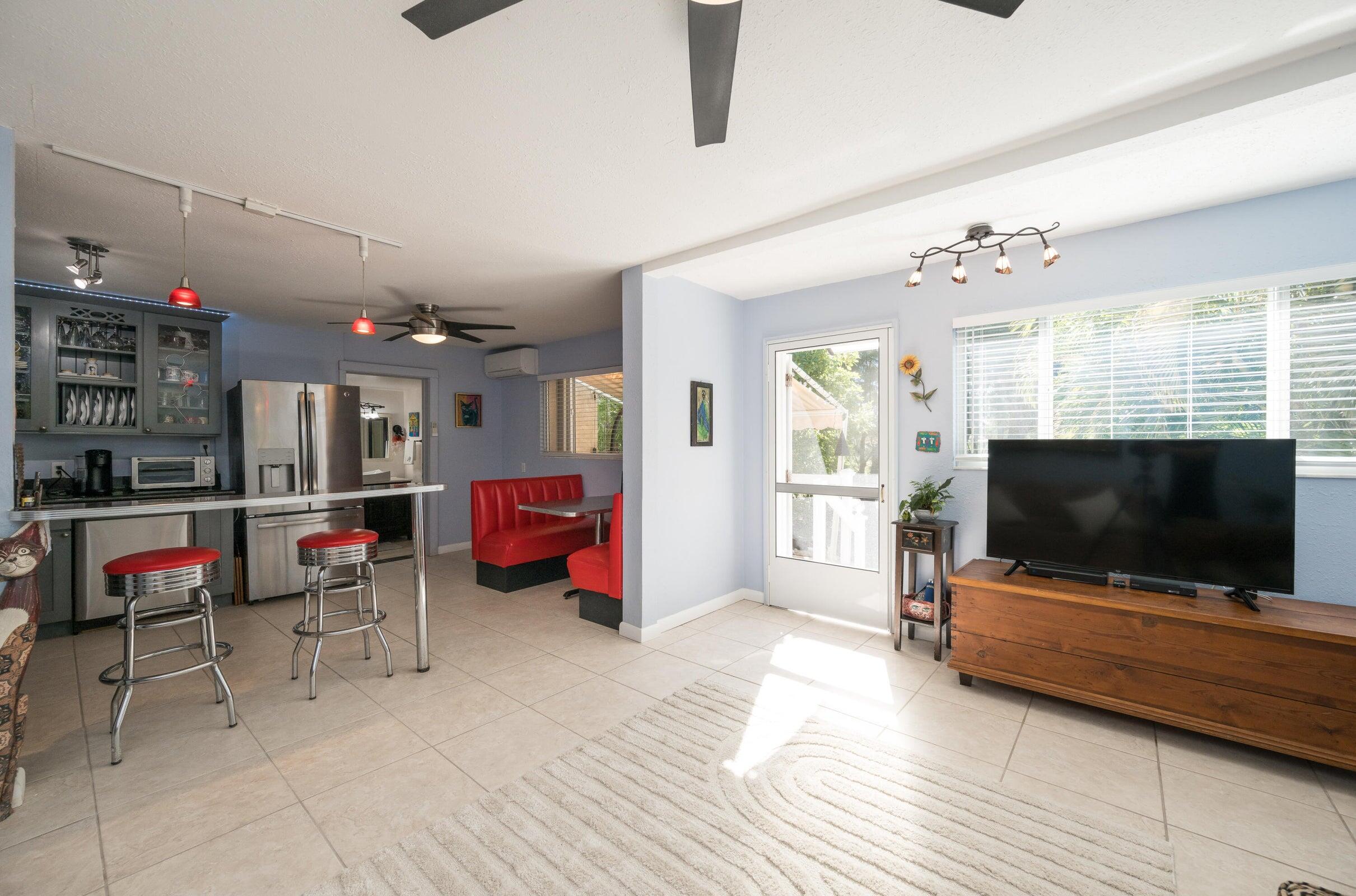 206 4th Street Key West, FL 33040 - Photo 24 of 44 a living room with furniture and a flat screen tv