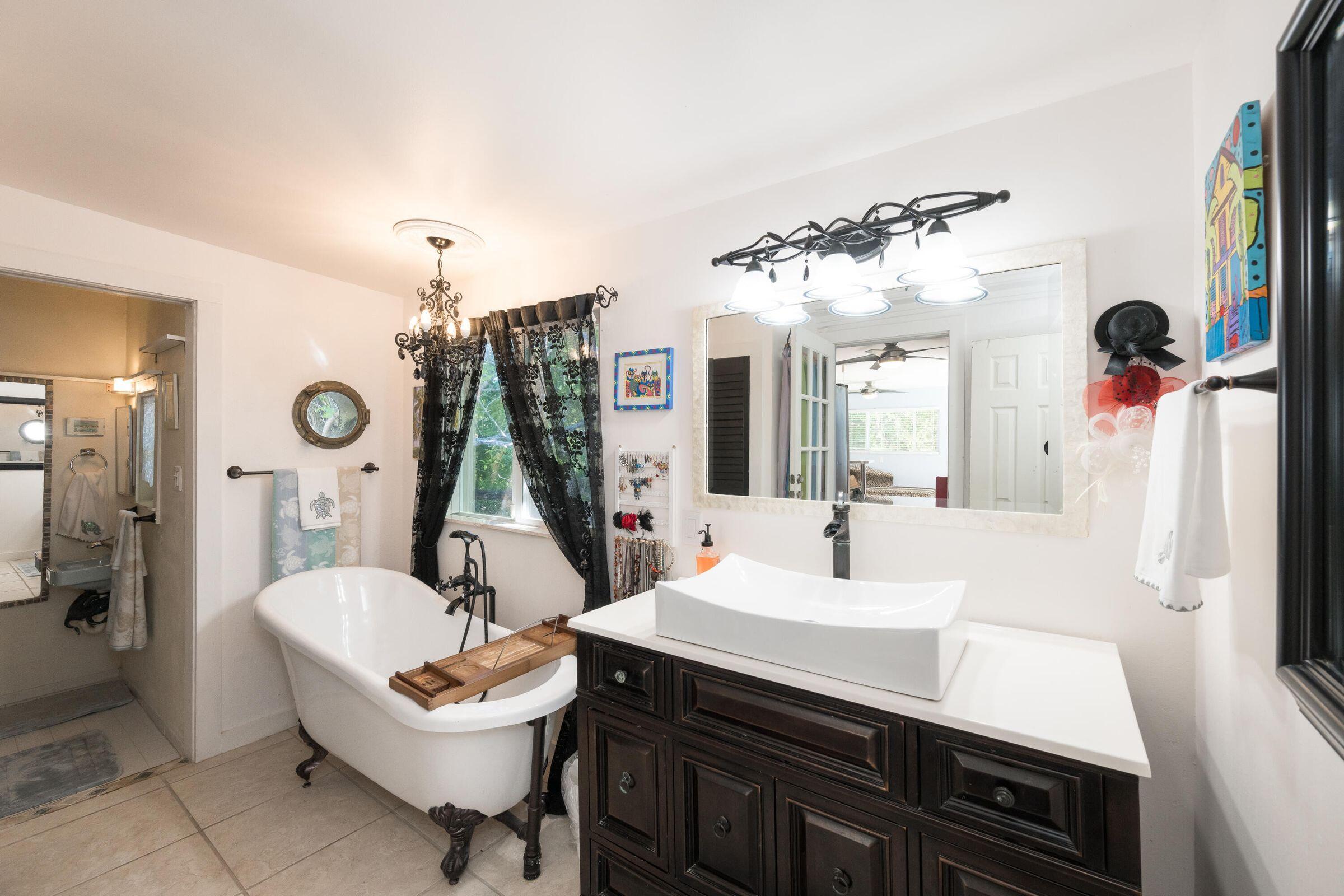 206 4th Street Key West, FL 33040 - Photo 28 of 44 a bathroom with a sink a toilet and a mirror
