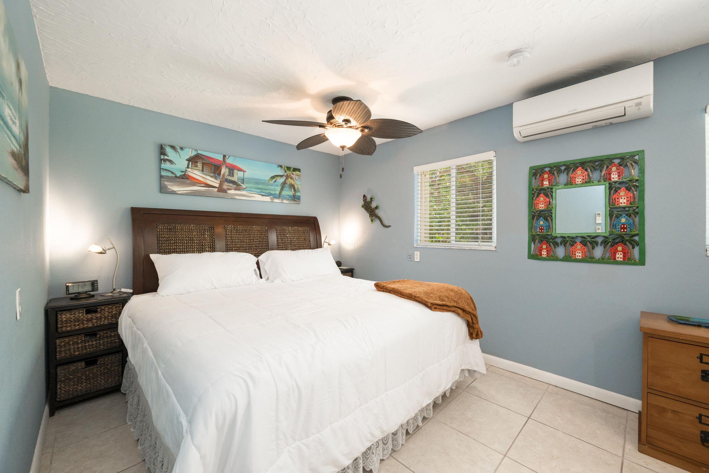 206 4th Street Key West, FL 33040 - Photo 32 of 44 a bedroom with a bed and a chandelier