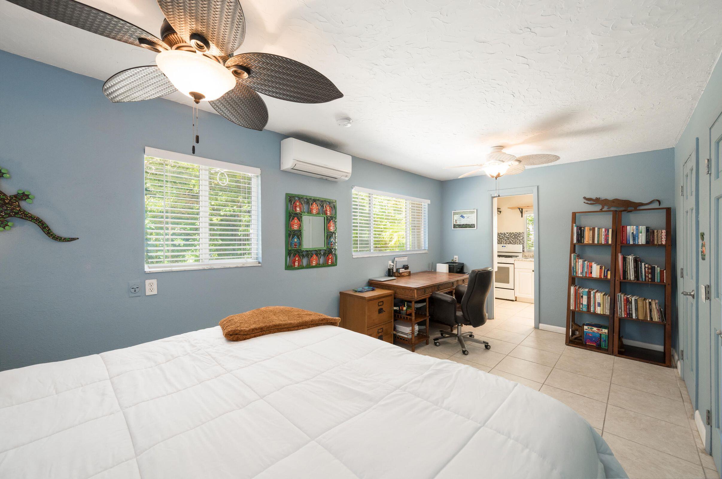 206 4th Street Key West, FL 33040 - Photo 33 of 44 a bedroom with a large bed and a chandelier