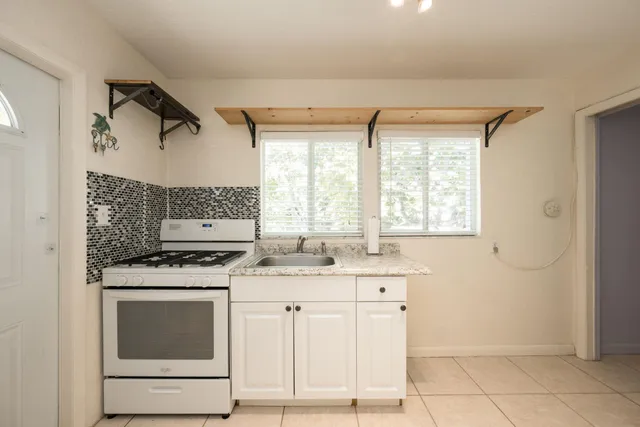 a bedroom with a bed couch and window