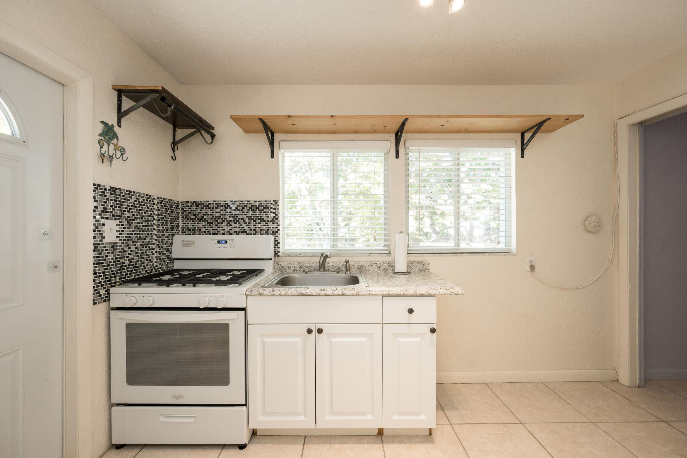 206 4th Street Key West, FL 33040 - Photo 36 of 44 a kitchen with a stove and a sink