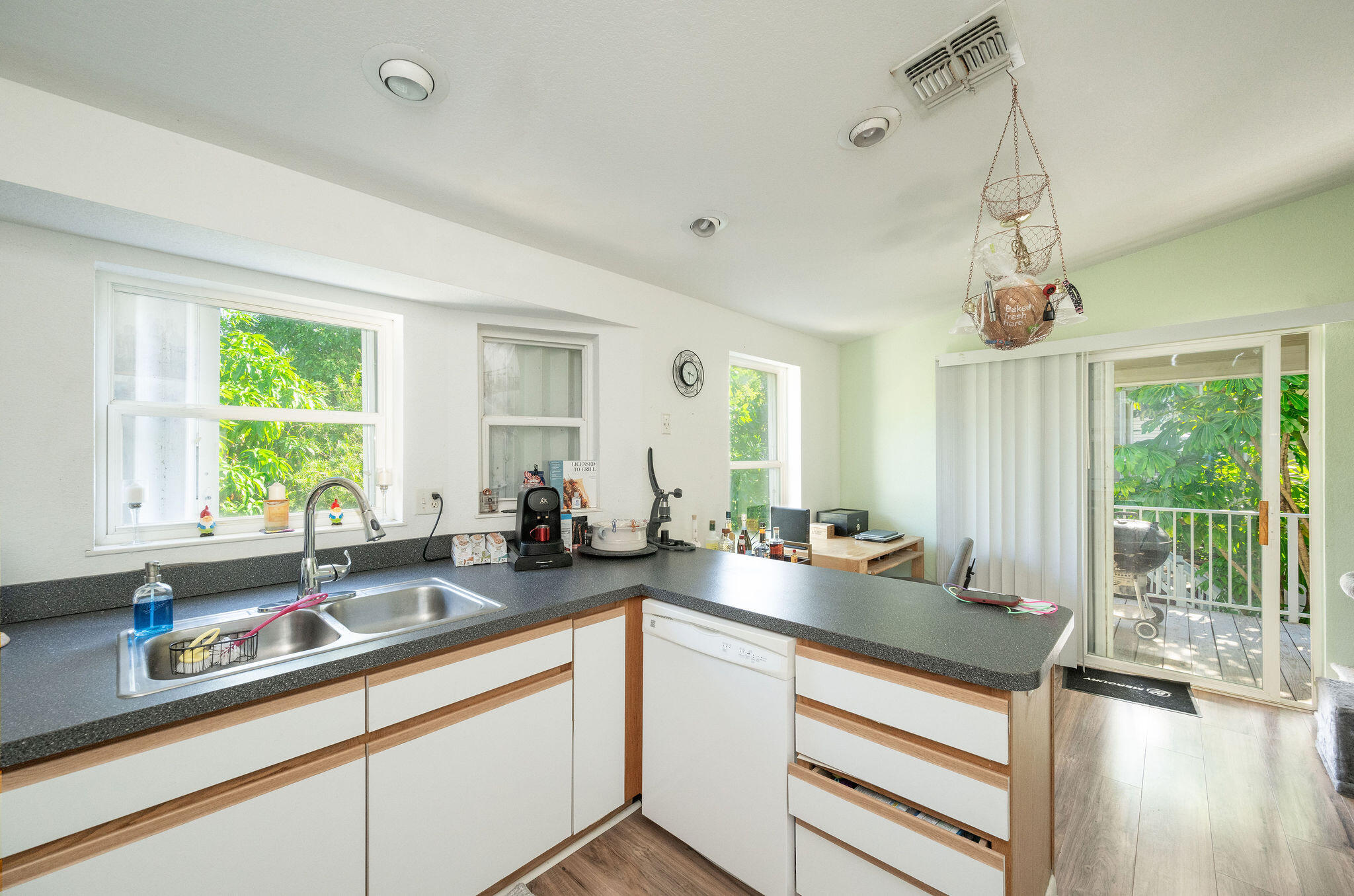 206 4th Street Key West, FL 33040 - Photo 8 of 44 a kitchen with a sink stove and cabinets