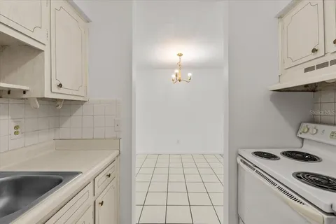 a kitchen with white cabinets and a sink