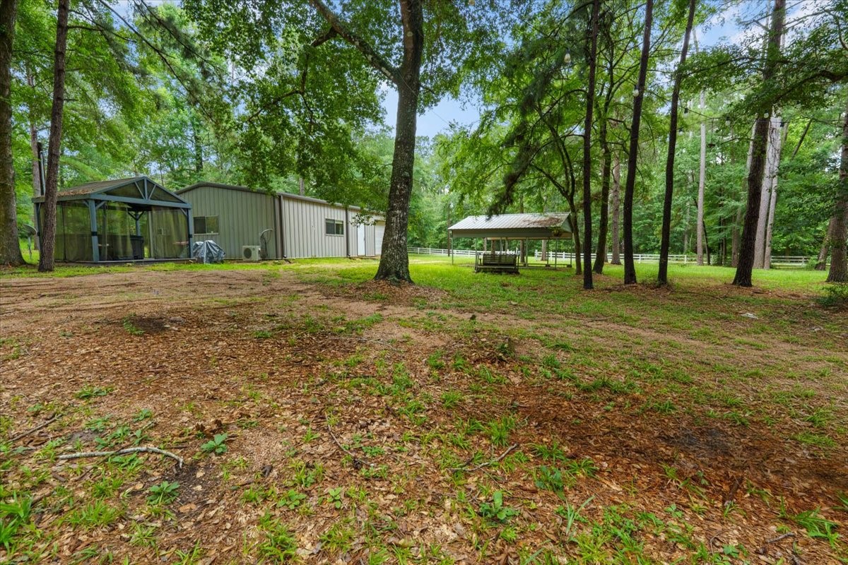 16375 Grand Flower Road Plantersville, TX 77363 - Photo 44 of 50 a house with trees in front of it