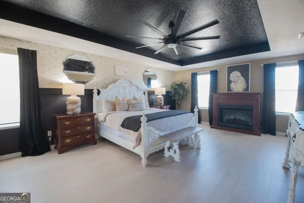 a spacious bedroom with a bed and a fireplace