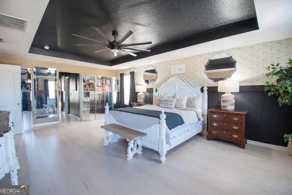 a bedroom with a bed window and dresser