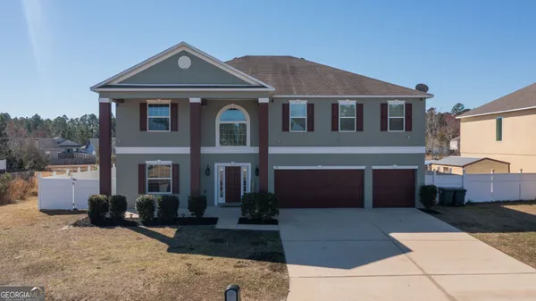 a front view of a house with a yard and garage