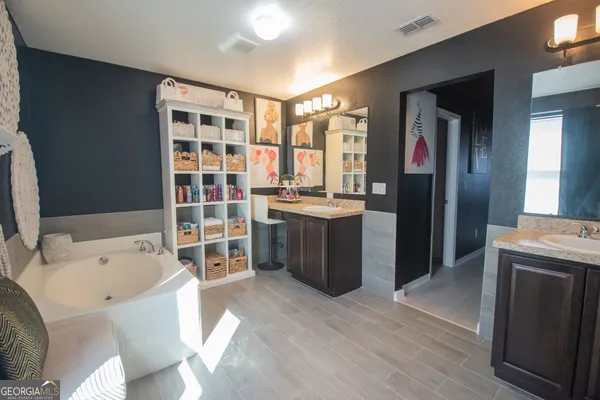 a kitchen with a sink appliances and cabinets