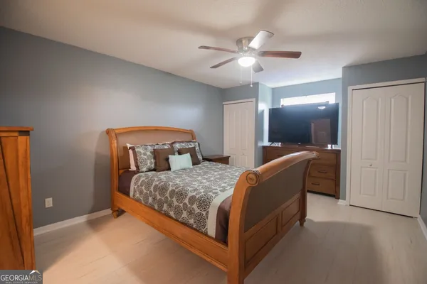 a bedroom with a bed and a chandelier