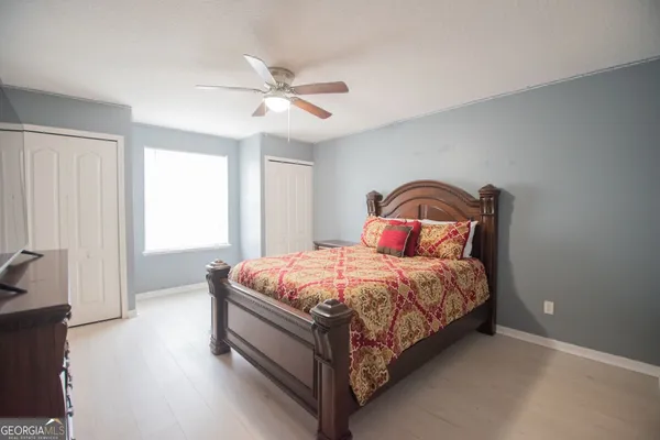 a bedroom with a bed and window