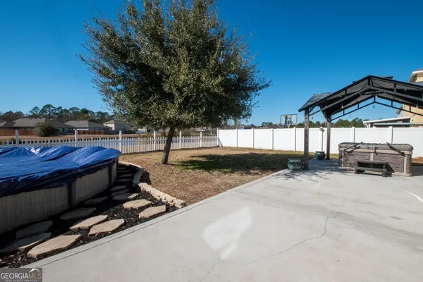a patio with water view fountain with outdoor seating