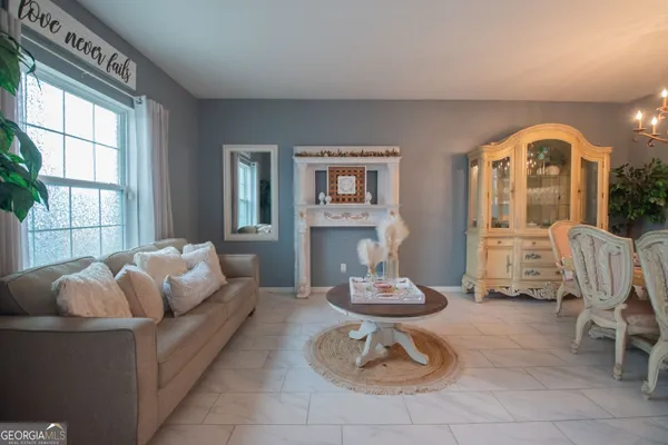 a living room with furniture a couch and a potted plant