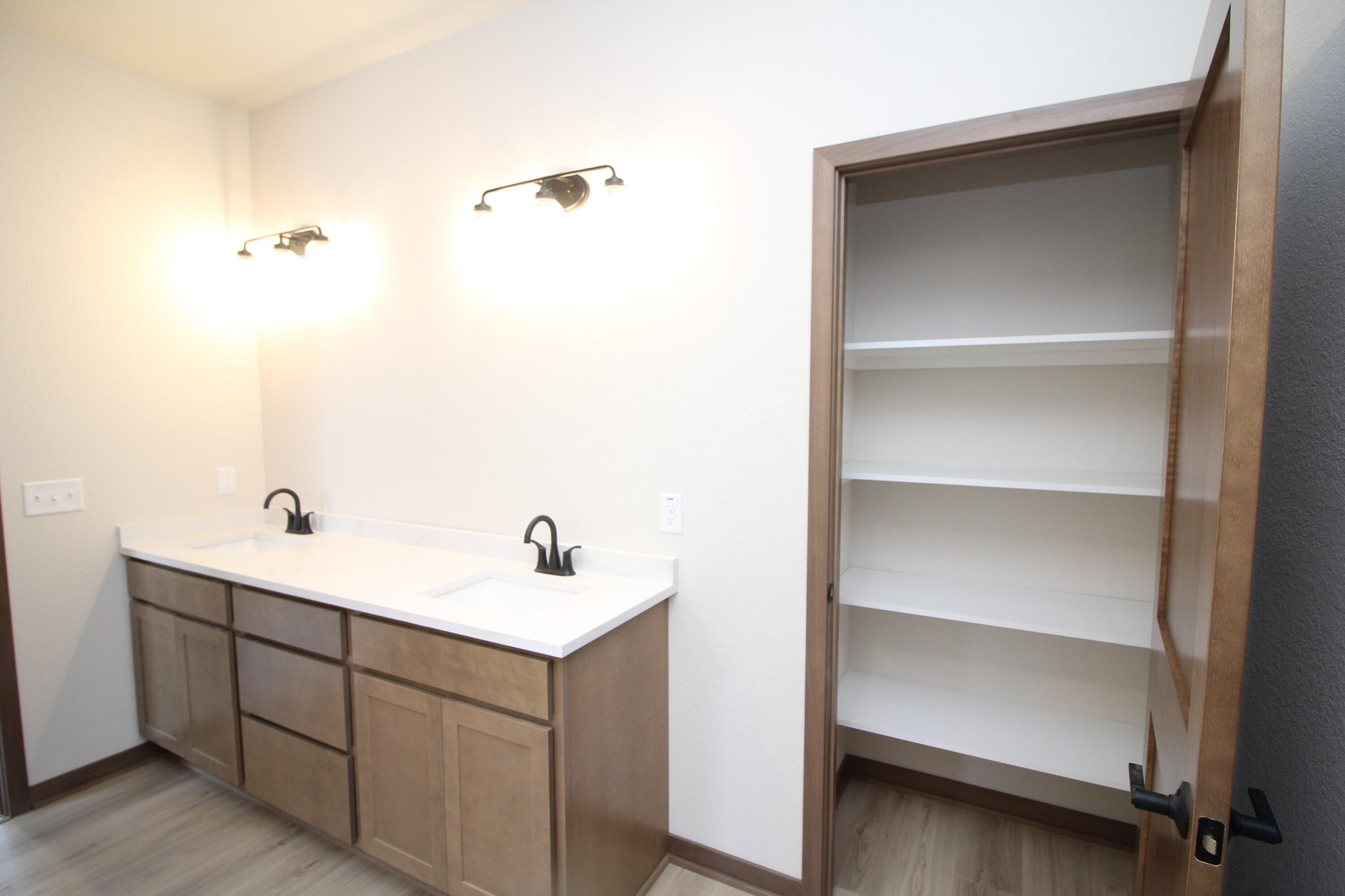 522 Calvin Lane Mount Pleasant, WI 53406 - Photo 13 of 23 Master bath with double sinks, quartz counters and linen closet