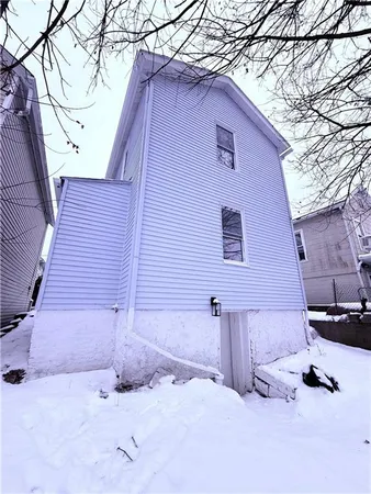 a backyard of a house with cars parked