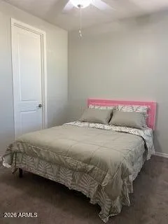 a bedroom with a bed and a night stand