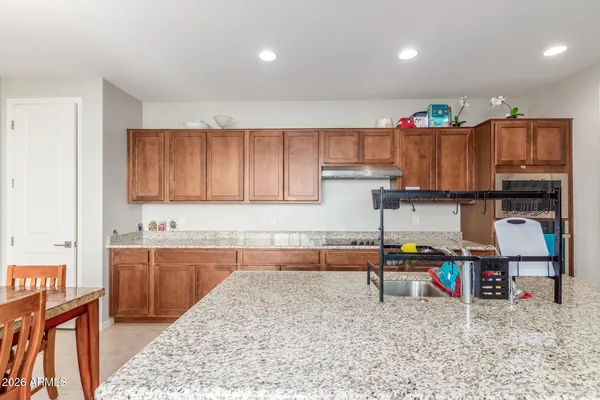a kitchen with stainless steel appliances granite countertop a sink stove and cabinets