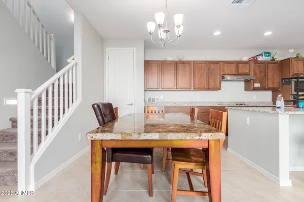 a kitchen with a table and chairs in it