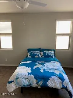 a bed sitting in a bedroom next to a window