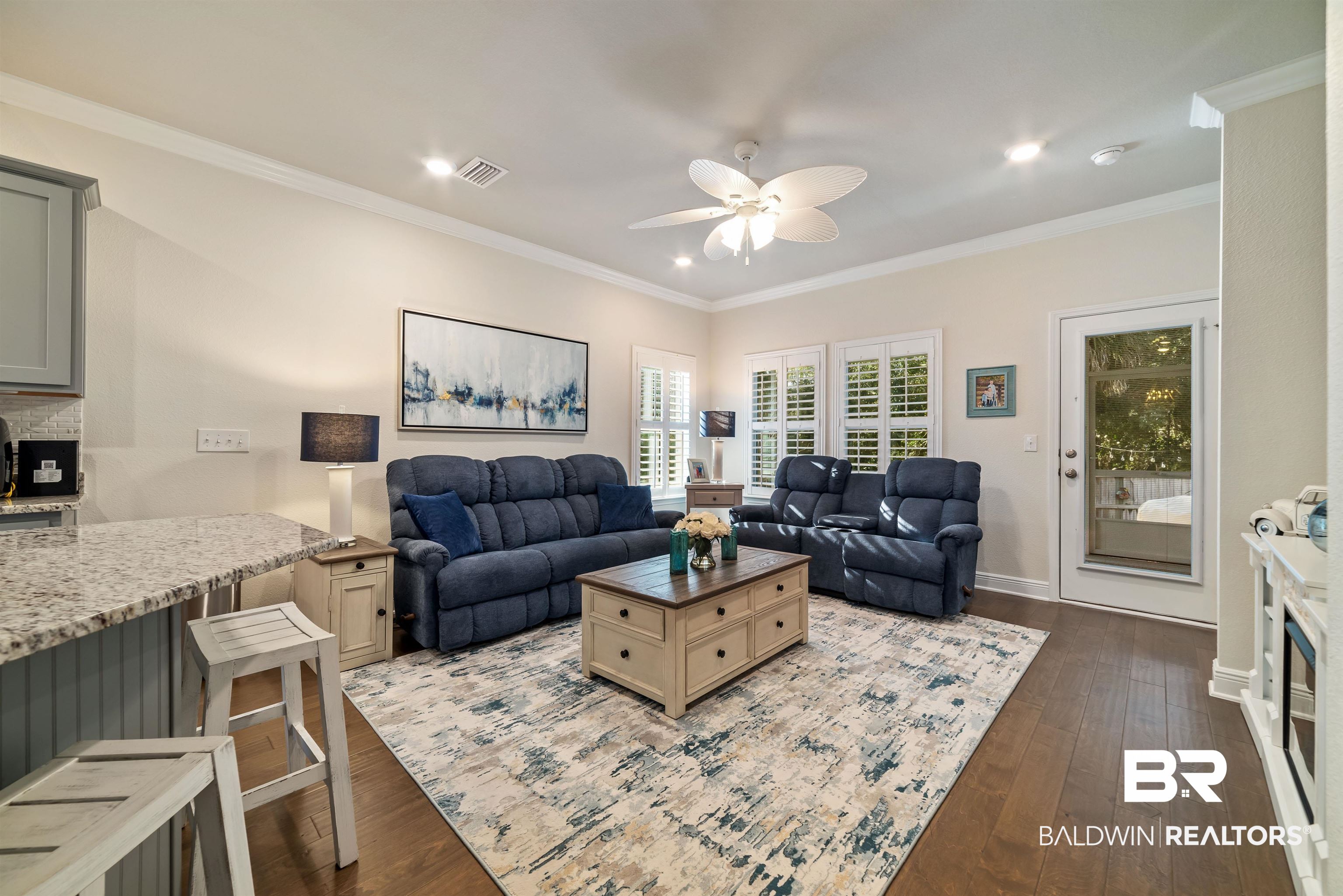 1290 Mako Loop Gulf Shores, AL 36542 - Photo 10 of 50 Living area with ceiling fan, dark wood-type flooring, visible vents, baseboards, and crown molding
