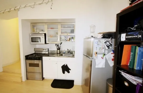 a kitchen with stainless steel appliances cabinets and a window