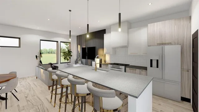 a kitchen with stainless steel appliances kitchen island granite countertop a table chairs and a refrigerator