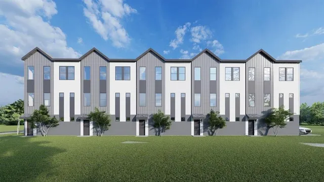 a front view of a residential houses with yard and green space