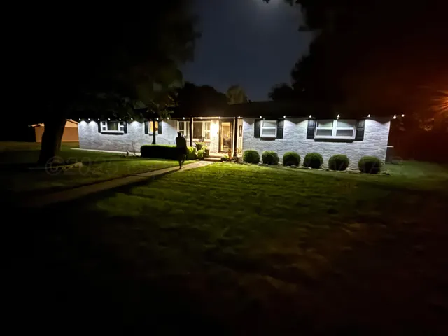 a front view of a house with a garden
