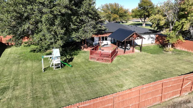 a backyard of a house with table and chairs