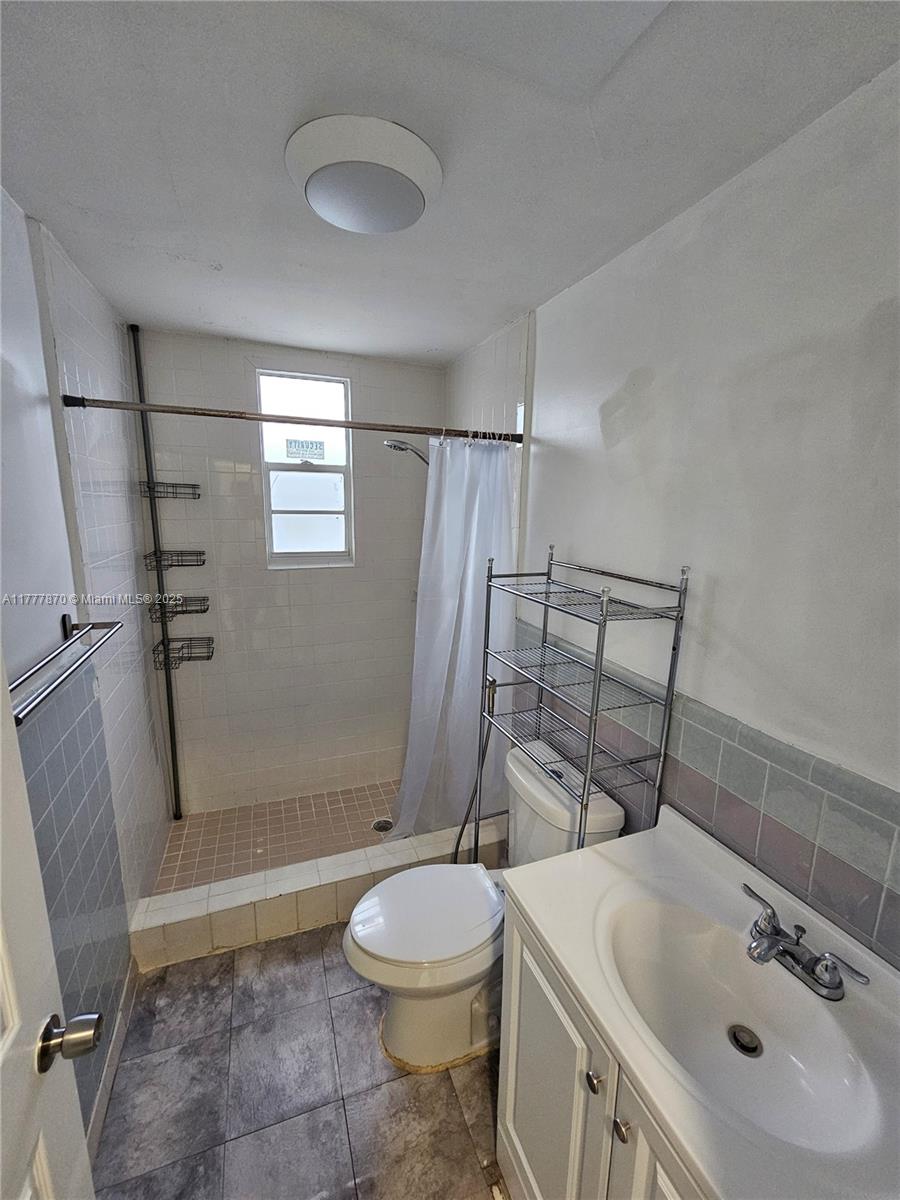 330 Southwest 79th Court, Unit 2 Miami, FL 33144 - Photo 6 of 9 a bathroom with a sink toilet and shower