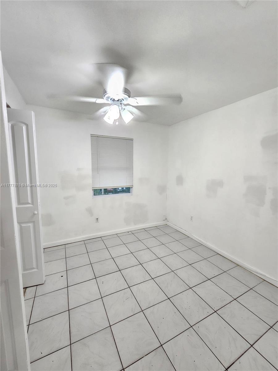 330 Southwest 79th Court, Unit 2 Miami, FL 33144 - Photo 7 of 9 a view of an empty room and chandelier fan