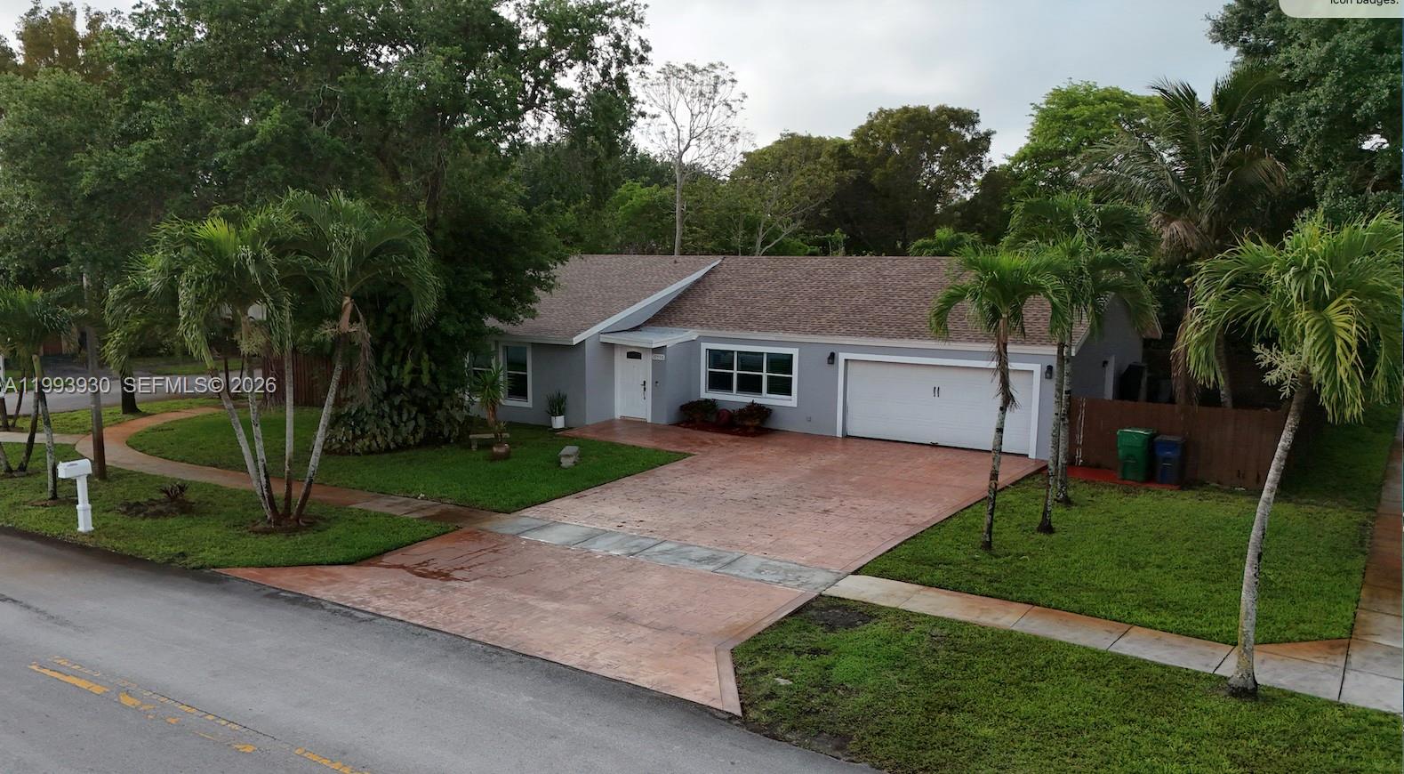 10550 Southwest 51st Street Cooper City, FL 33328 - Photo 1 of 37 a aerial view of a house with a yard and palm trees
